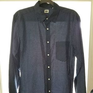 Tiny white polka dots on navy blue long sleeve button up. Chest pocket included.